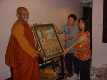 International Vesak day in Thiland 2006 - offering a Buddha's picture.jpg